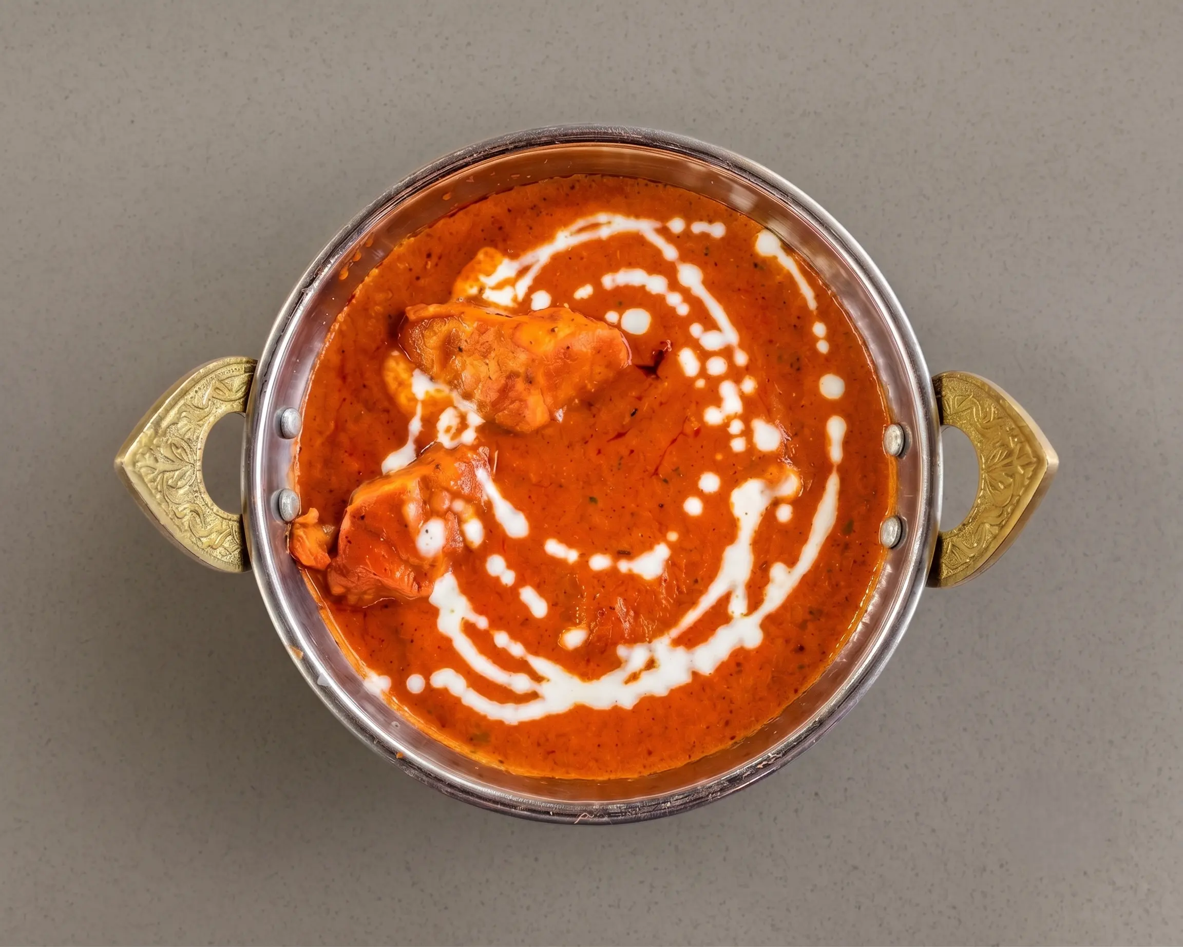 Butter chicken curry served with garlic naan at Haandi Indian Cuisine, Calgary